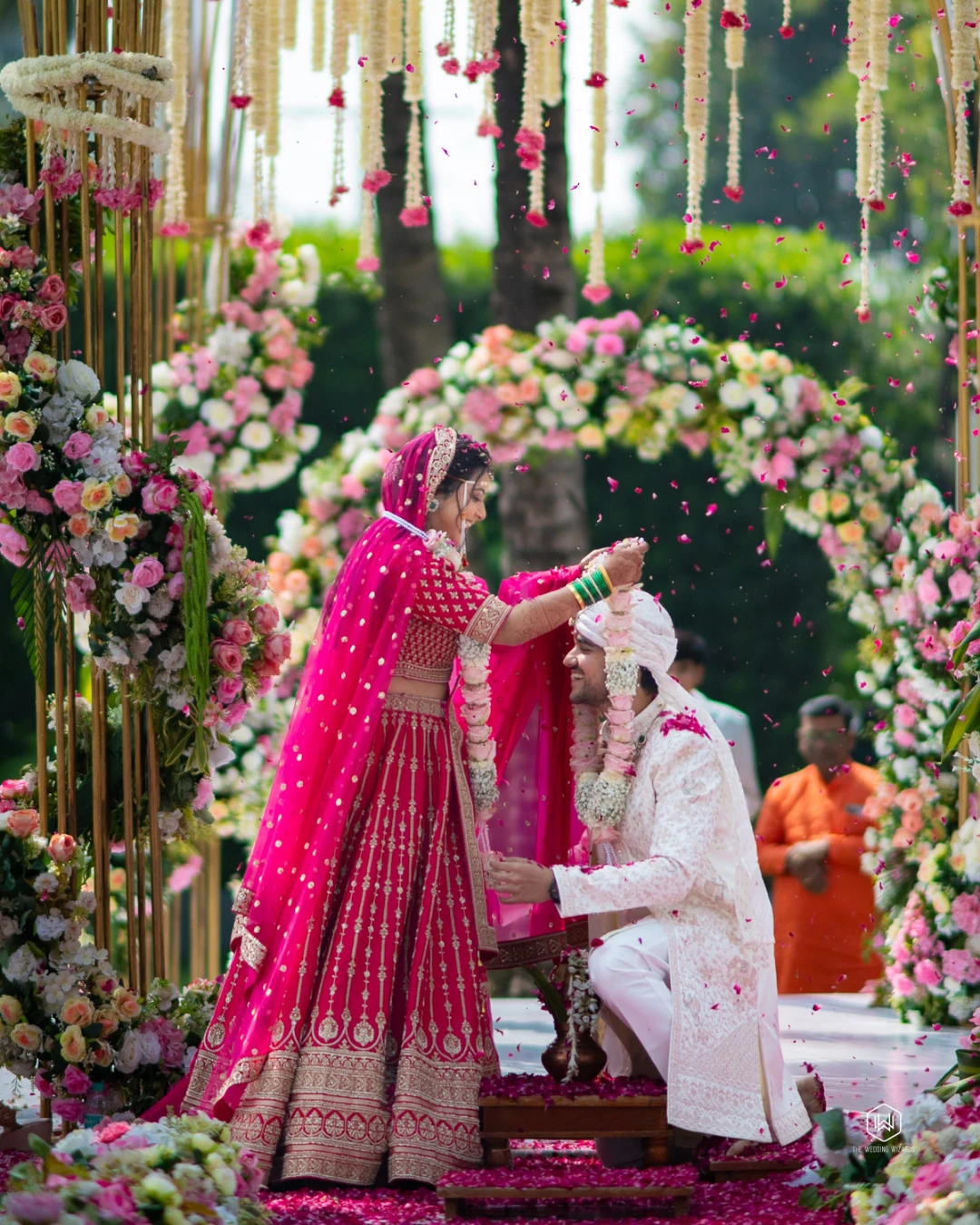 A varmala exchange in a shower of petals