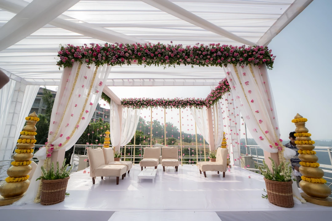 A rose-draped mandap on a terrace