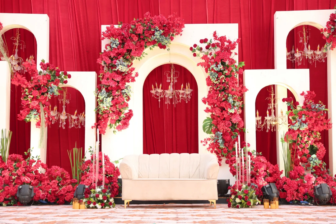A crimson floral arch stage