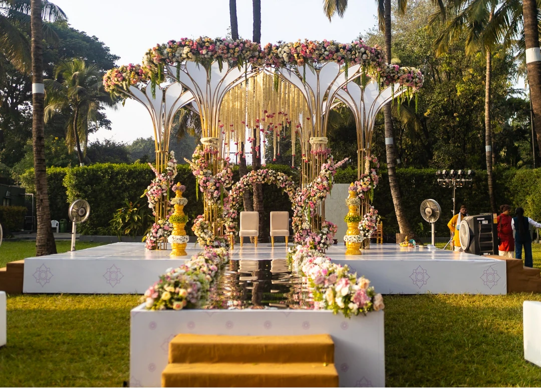 A gilded mandap on an open lawn