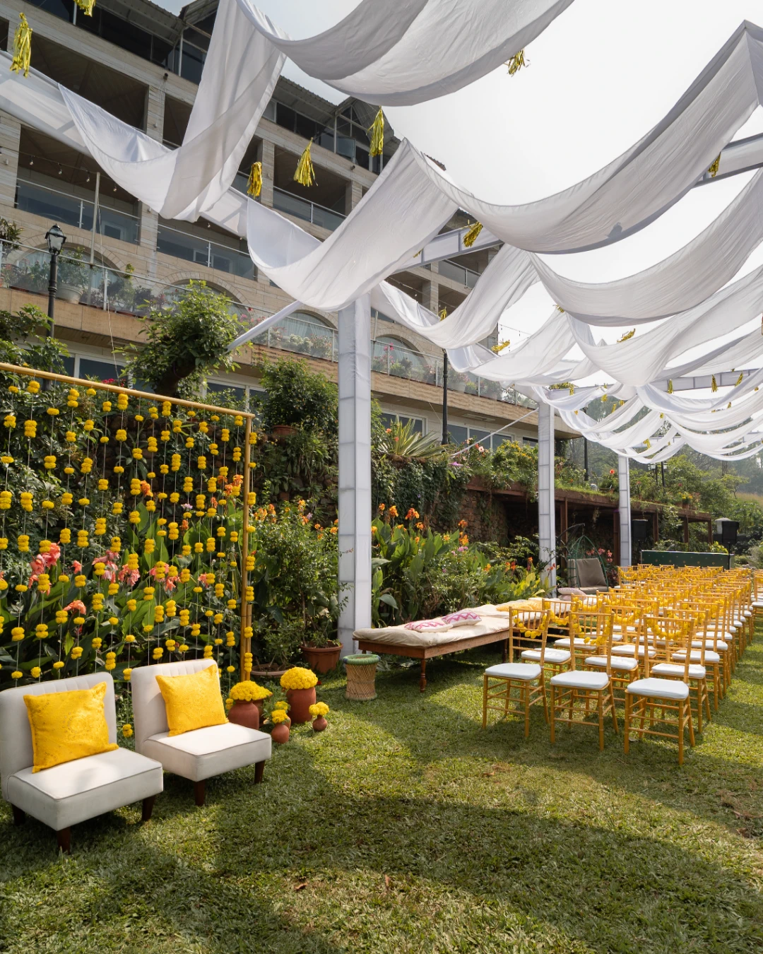 A marigold haldi set on the lawn — Gātha