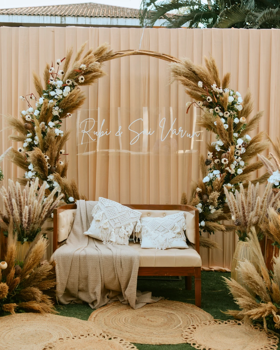 A pampas arch behind a lounge sofa