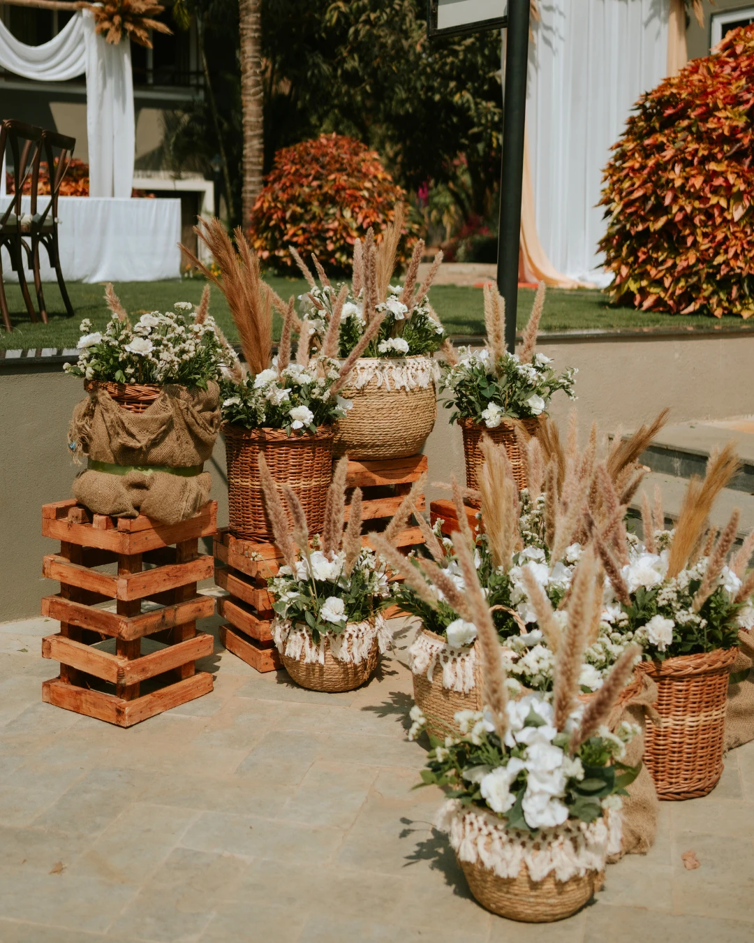 Pampas and white blooms in cane baskets — Gātha