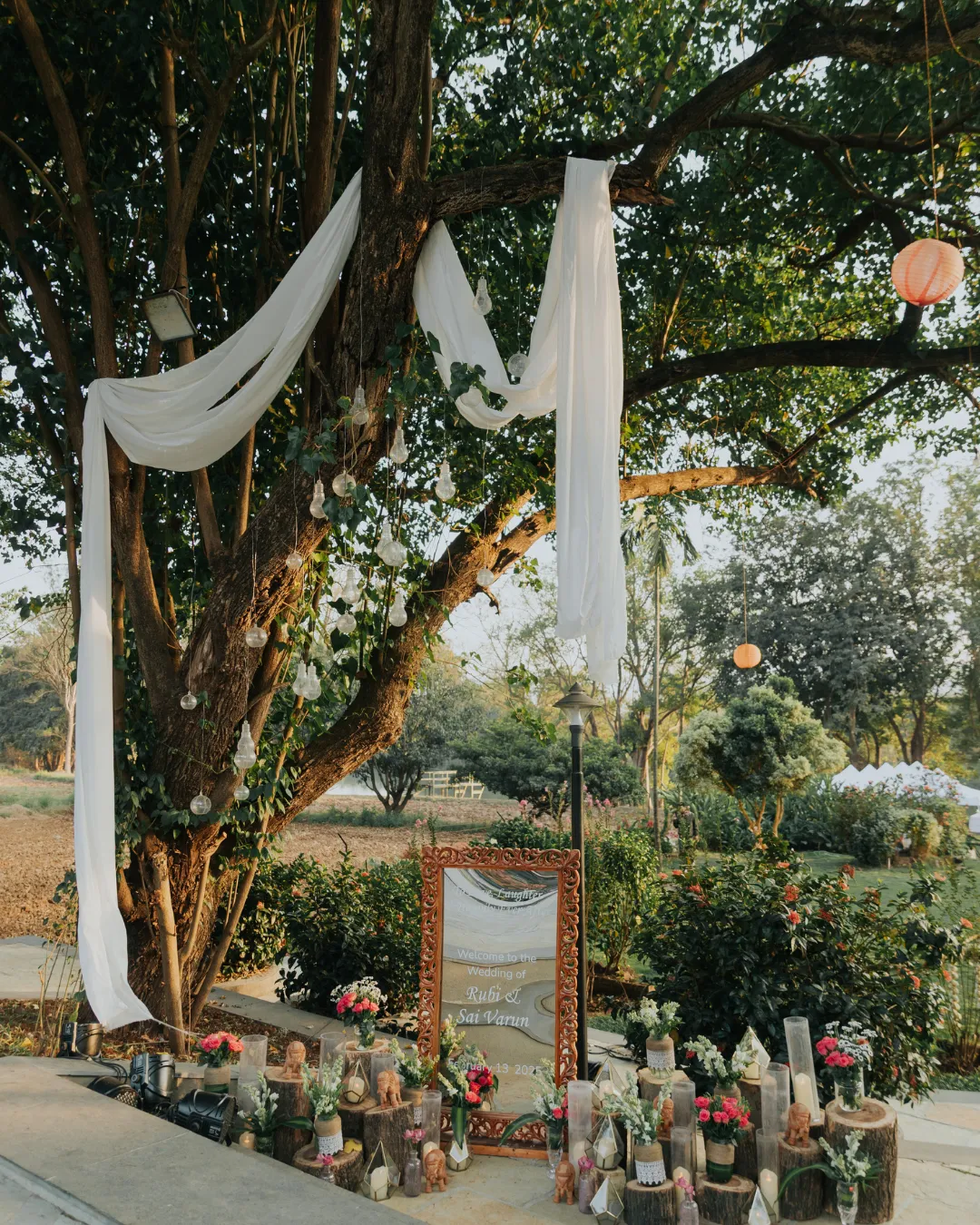 A draped tree and a mirrored welcome sign — Gātha
